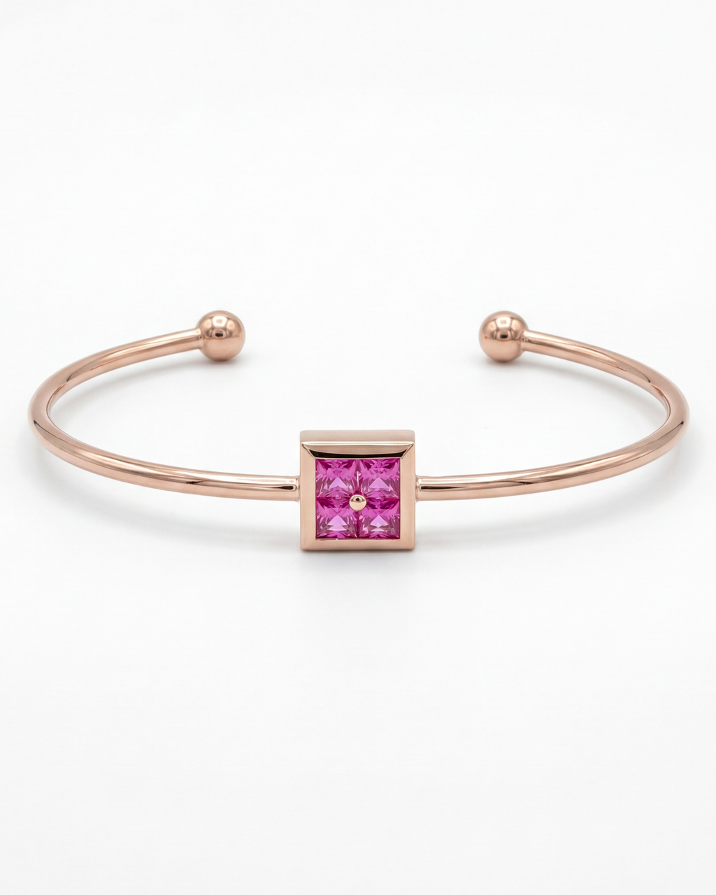 Rose gold bracelet with a pink gemstone on a white background