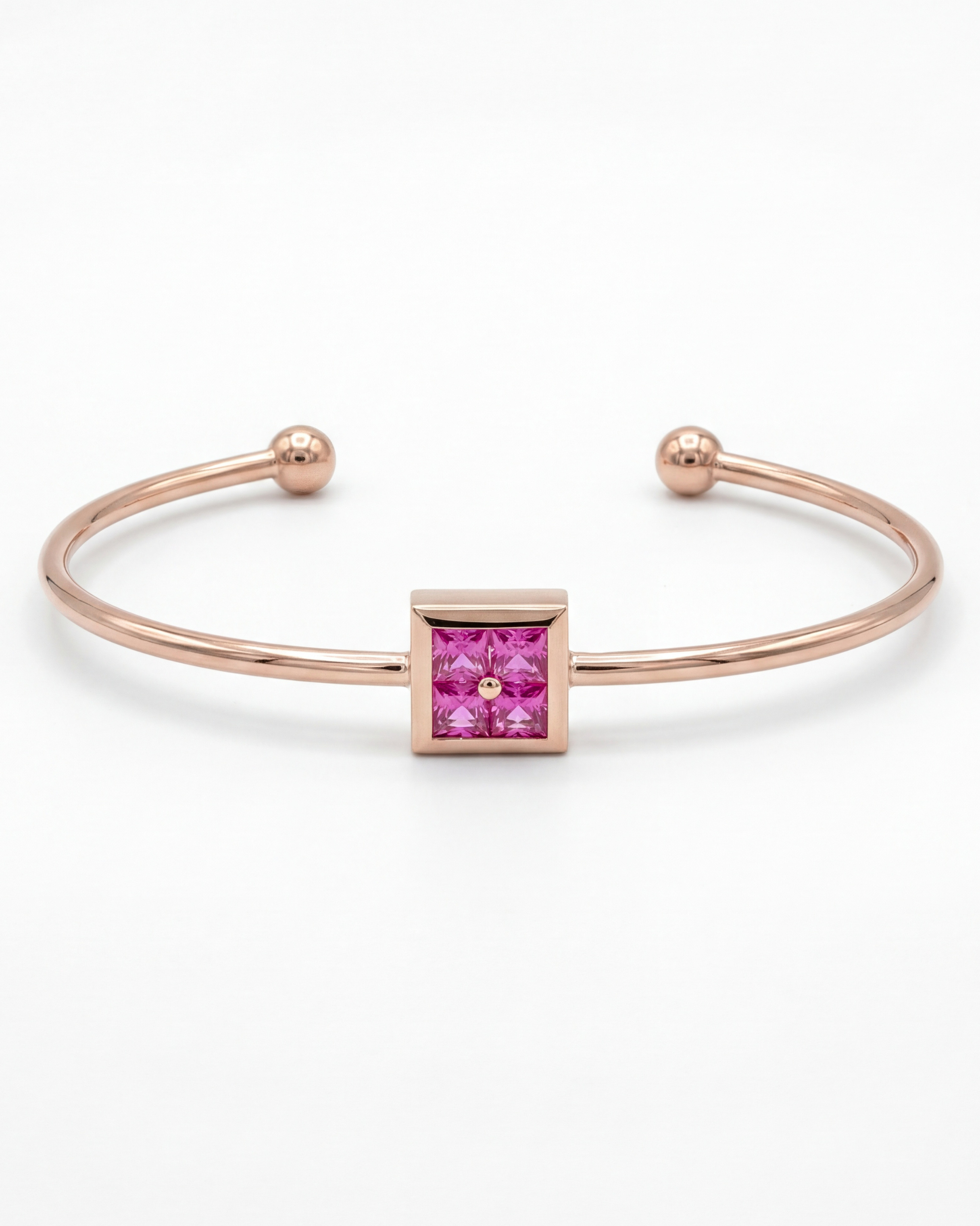 Rose gold bracelet with a pink gemstone on a white background