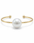 Gold bracelet with a large pearl on a white background