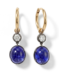 Gold earrings with blue gemstones and diamonds on a white background