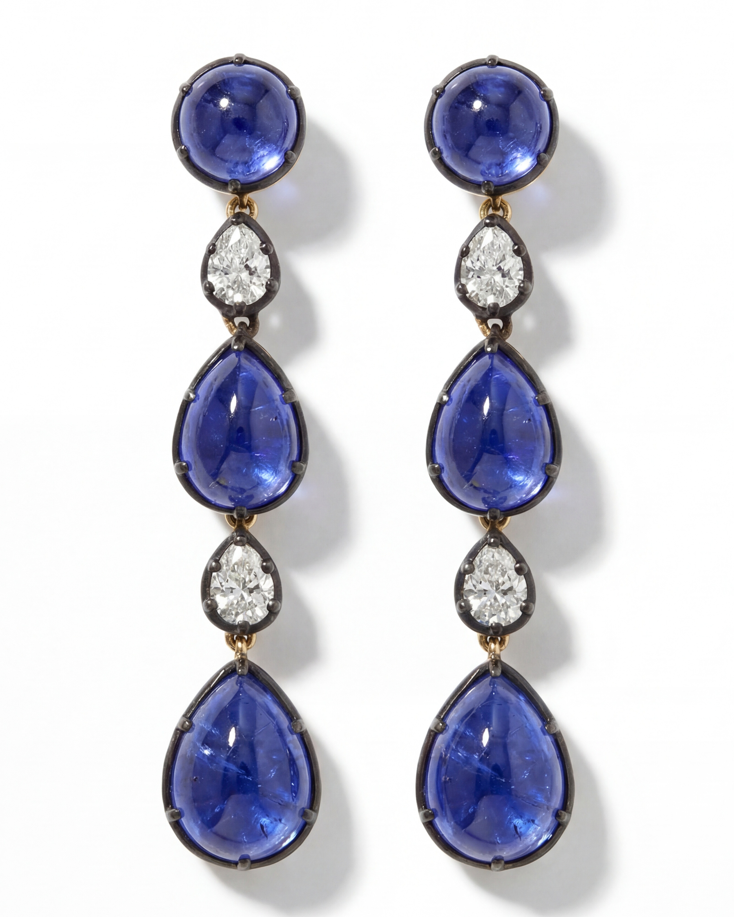 Pair of blue teardrop earrings with diamond accents on a white background